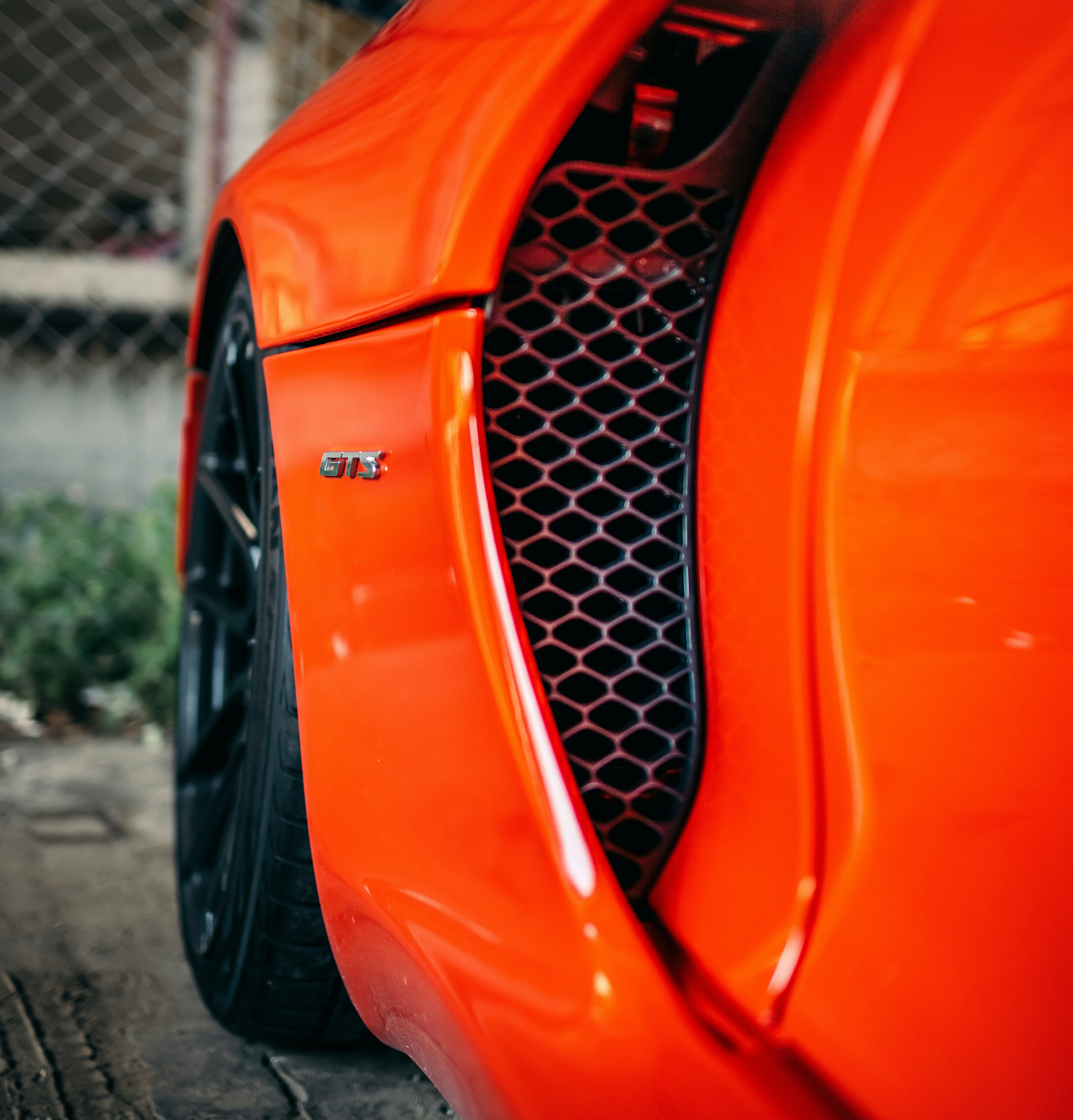 orange and black car on road during daytime